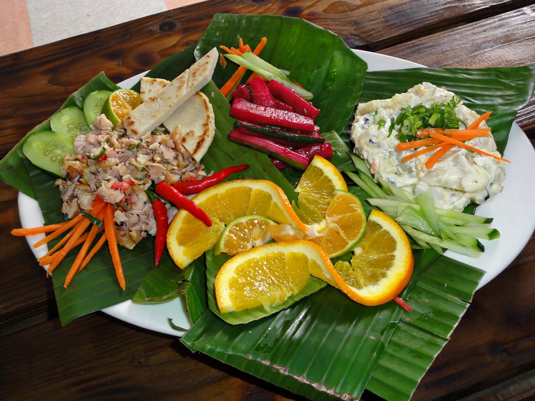 Chamorro- beef kelaguen and potato salad in banana leaves